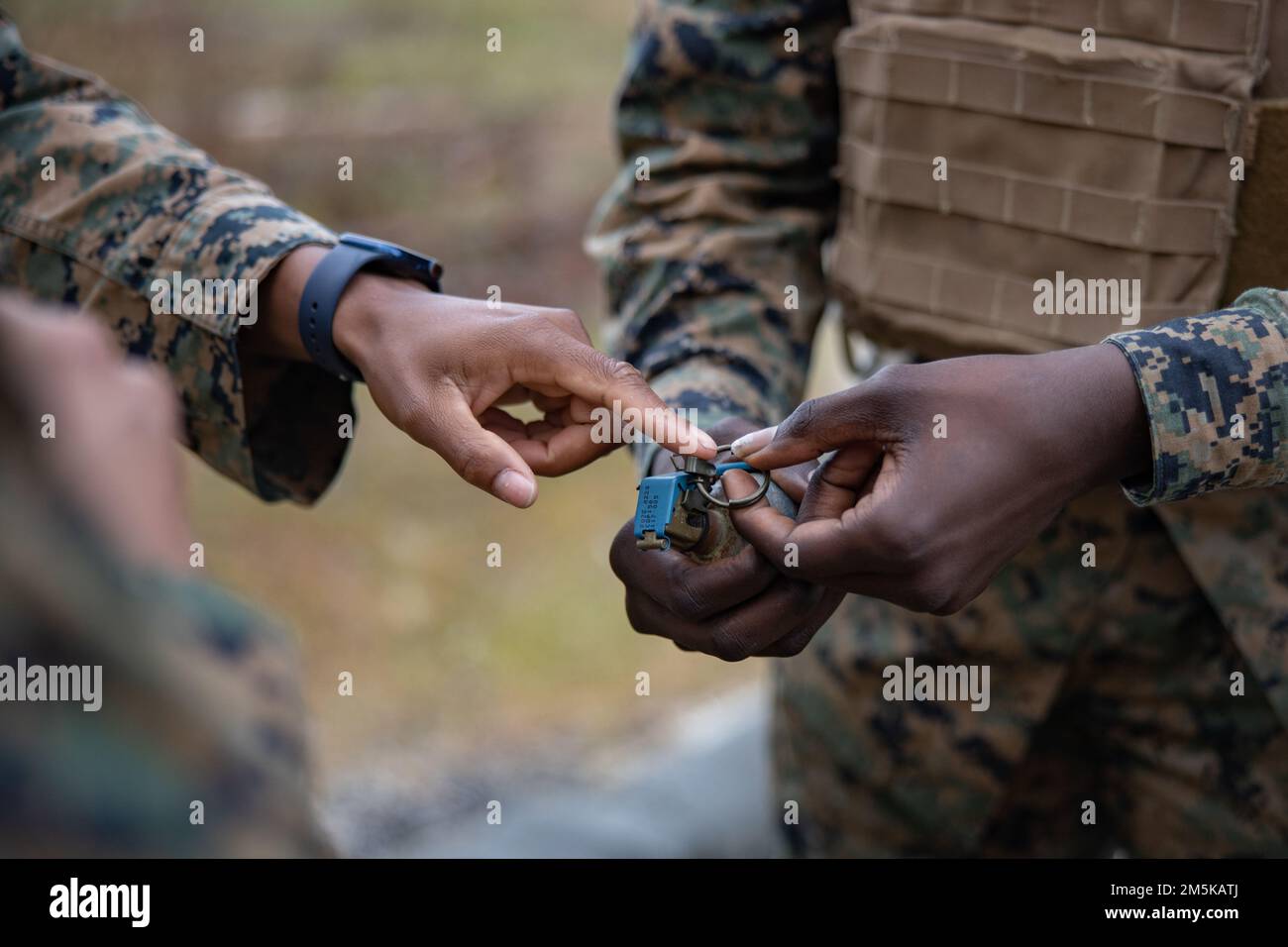 A U.S. Marine with Combat Logistics Battalion 451, 4th Marine Logistics Group, points to a pin on an M67 grenade during a live fire grenade range on Camp Lejeune, North Carolina, March 22, 2022. Marines and Sailors with CLB-451 are participating in annual training and demobilization facilitated by the Marines of Combat Logistics Regiment 2, 2nd Marine Logistics Group. Stock Photo