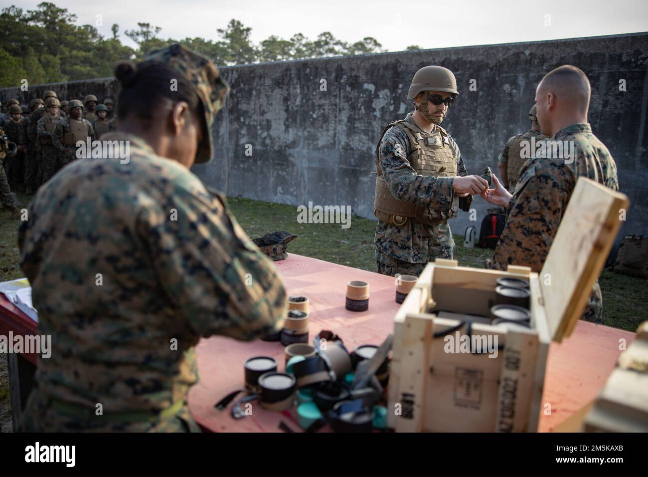 U.S. Marines with Combat Logistics Battalion 451, 4th Marine Logistics Group, are given M67 grenades during a live fire grenade range on Camp Lejeune, North Carolina, March 22, 2022. Marines and Sailors with CLB-451 are participating in annual training and demobilization facilitated by the Marines of Combat Logistics Regiment 2, 2nd Marine Logistics Group. Stock Photo