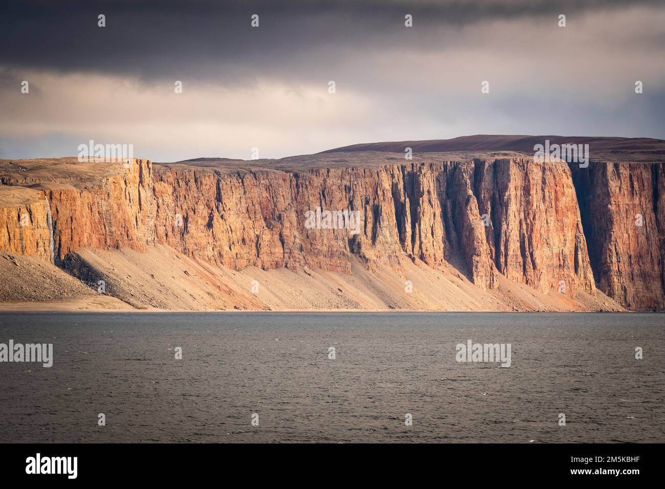 Cliffs on the shoreline of Adams Sound off Admiralty Inlet near Arctic Bay, Nunavut, Canada. Stock Photo