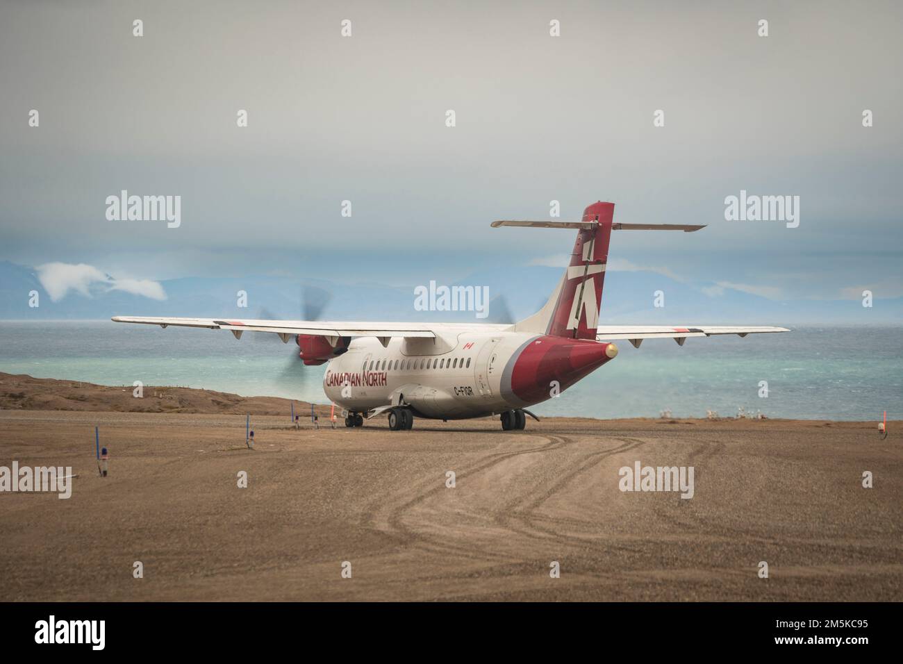 ATR 72 cargo and passenger aircraft belonging to Canadian North Airlines on the gravel airstrip at Pond Inlet, Baffin Island, Nunavut, Canada. Stock Photo
