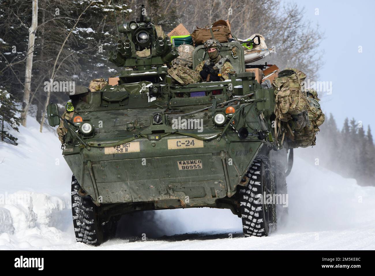 A Stryker vehicle from the 3rd Battalion, 21st Infantry Regiment moves down a snowy road in the Donnelly Training Area during Joint Pacific Multinational Readiness Center 22-02, March 22, 2022. This exercise is designed to validate U.S. Army Alaska’s 1st Stryker Brigade Combat Team, 25th Infantry Division’s cold weather training, readiness and capabilities.  (Army photo/John Pennell) Stock Photo