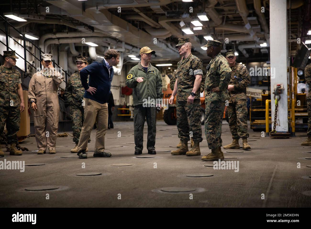 220322-N-LZ839-1689  NORFOLK, VA. (March 22, 2022) - Brig. Gen. Mark H. Clingan, Assistant Deputy Commandant, Combat Development and Integration, and the Capt. Joseph Murphy, commanding officer of the amphibious assault ship USS Bataan (LHD 5), tour the upper vehicle stowage area, March 22, 2022. Bataan is homeported at Naval Station Norfolk. Stock Photo