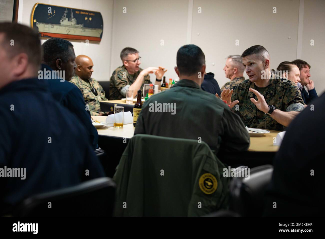 220322-N-LZ839-1499  NORFOLK, VA. (March 22, 2022) - Brig. Gen. Mark H. Clingan, Assistant Deputy Commandant, Combat Development and Integration, eats lunch with Capt. Joseph Murphy the commanding officer of the amphibious assault ship USS Bataan (LHD 5) during a tour of Bataan,  March 22, 2022. Bataan is homeported at Naval Station Norfolk. Stock Photo