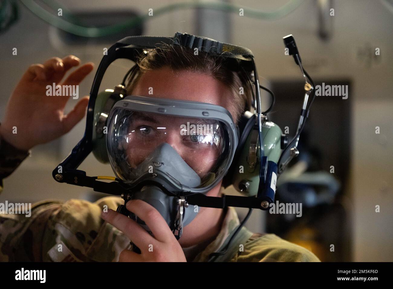 U.S. Air Force Capt. Judy Hipelius, 60th Aeromedical Evacuation Squadron flight nurse, is timed donning fire emergency gear in a C-17 Globemaster III at Travis Air Force Base, California, March 22, 2022. The AE mission is to provide trusted care in the air for service members, dependents, veterans and allies. Stock Photo