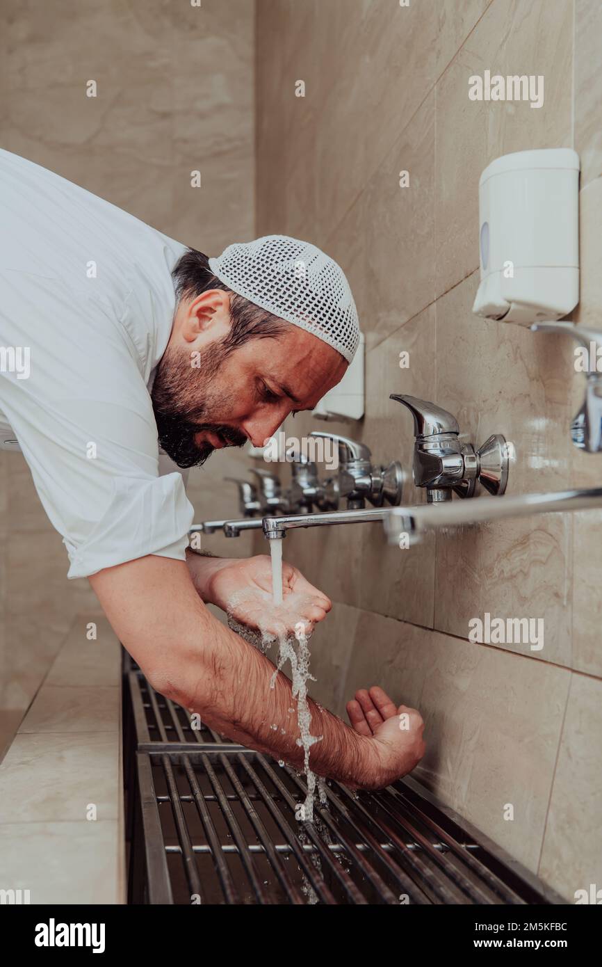 A Muslim performing ablution. Ritual religious cleansing of Muslims ...
