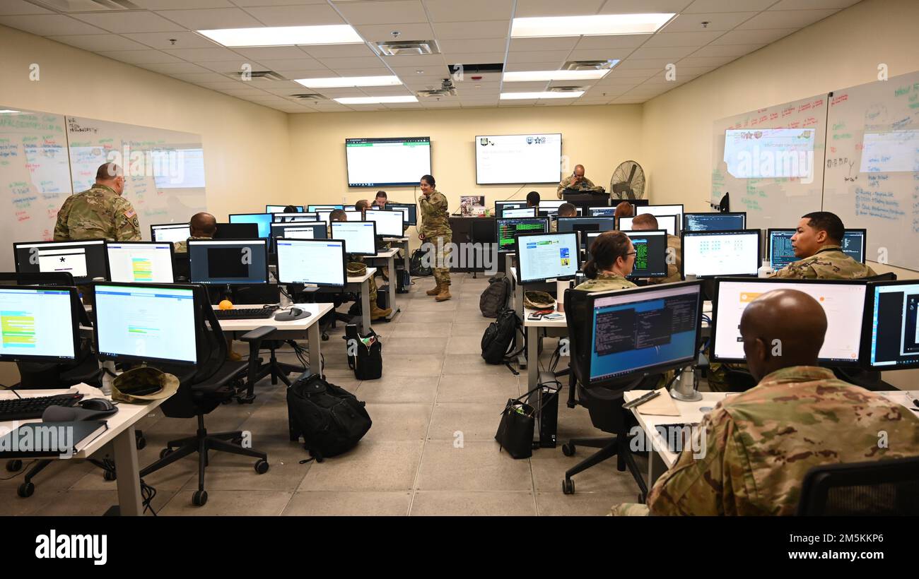 Members of the 175th Cyberspace Operations Group and the 169th Cyber Protection Team, Maryland Air National Guard prepare their workstations before the start of Cyber Blitz 22-3 at Warfield Air National Guard Base, Middle River, Maryland on March 23, 2022. The Cyber Blitz exercise is a constantly evolving cyber exercise, which aims to deliver realistic offensive operations and adversarial effects against cyber protection elements conducting defensive operations on a virtual network. Stock Photo