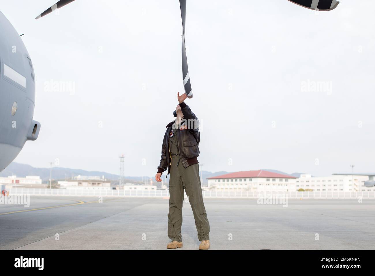 U.S. Marine Corps Capt. Carolyn Pushaw, a KC-130J Super Hercules pilot with Marine Aerial Refueler Transport Squadron (VMGR) 152 conducts pre-flight checks at Marine Corps Air Station Iwakuni, Japan, March 23, 2022. Marines with VMGR-152 supported Marines with Marine Fighter Attack Squadron 121 during a training flight simulating close air support at Camp Fuji, Japan. Marine Corps aviation routinely conducts training throughout the region to remain combat-ready in support of a free and open Indo-Pacific and to demonstrate our commitment to the Treaty of Mutual Cooperation and Security between Stock Photo