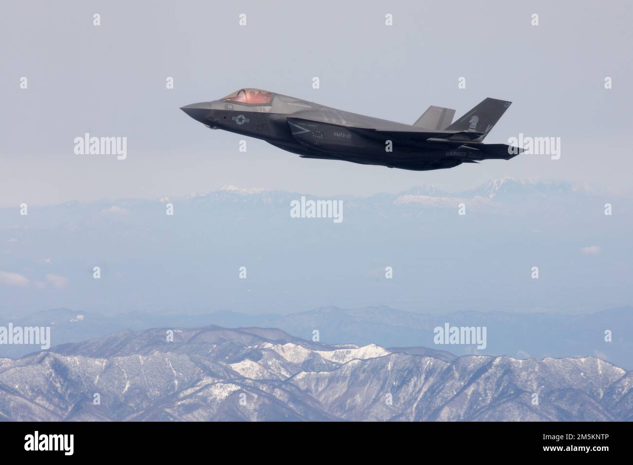 A U.S. Marine Corps F-35B Lightning II with Marine Fighter Attack Squadron (VMFA) 121 flies near Mt. Fuji, Japan, March 23, 2022. Marines with Marine Aerial Refueler Transport Squadron 152 supported Marines with VMFA-121 during a training flight simulating close air support at Camp Fuji, Japan. Marine Corps aviation routinely conducts training throughout the region to remain combat-ready in support of a free and open Indo-Pacific and to demonstrate our commitment to the Treaty of Mutual Cooperation and Security between the U.S. and Japan. Stock Photo