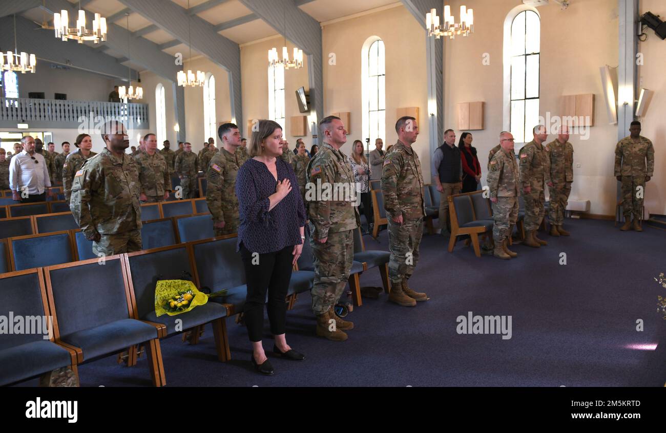 U.S. Soldiers, friends and distinguished visitors render honors during the singing of the German national anthem, during the Public Health Command Europe Relinquishment of Responsibility Ceremony, March 23, 2022 at Landstuhl, Germany. Stock Photo