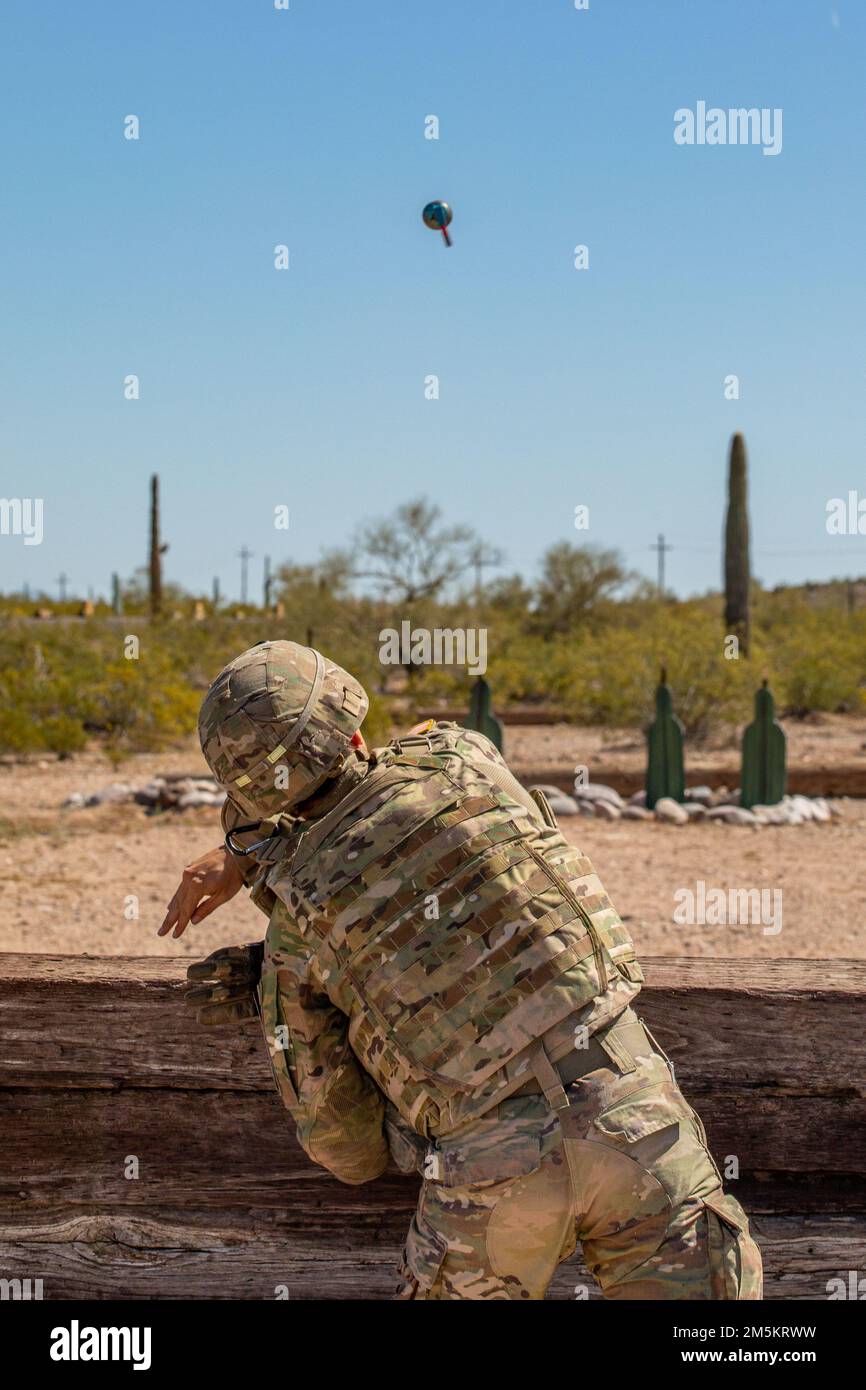 U.S. Army 2nd Lt. Jose Aguilar with the 996th Area Support Medical Company tosses an M69 practice grenade during the grenade challenge event at Florence Military Reservation, in Florence, Ariz., March 23, 2022.    Soldiers competing in this event have the unique opportunity to bring any specialized knowledge gained back to their home units, improving upon the overall readiness of the Arizona National Guard Stock Photo