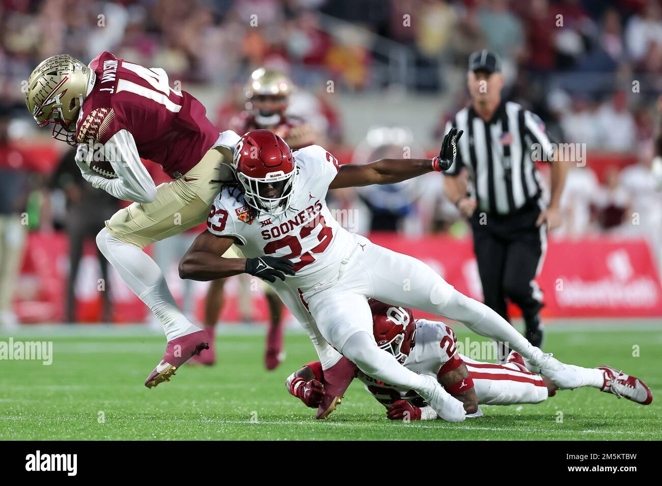 December 29, 2022: Florida State Seminoles wide receiver JOHNNY WILSON (14) gets tackled during the 2022 NCAA Cheez-It Bowl game between the Florida State Seminoles and Oklahoma Sooners at Camping World Stadium in Orlando, FL on December 29, 2022. (Credit Image: © Cory Knowlton/ZUMA Press Wire) Stock Photo