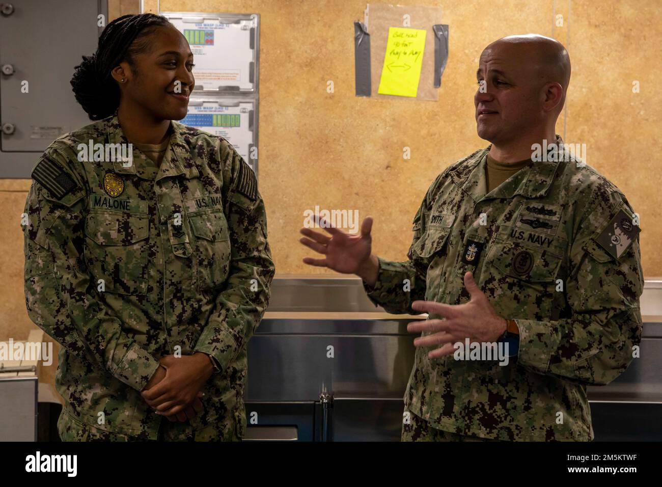 220323-N-OX029-1028  NORFOLK (March 23, 2022) - Master Chief Petty Officer of the Navy Russell Smith gives advice to Master-at-Arms Second Class Kelsea Malone after her meritorious advancement on the mess decks of the amphibious assault ship USS Wasp (LHD 1), March 23, 2022. MCPON Smith visited Norfolk, Va., to meet with local commands to engage with Sailors to discuss their concerns, quality of life issues, and champion Chief of Naval Operations, Adm. Mike Gilday's ‘Get Real, Get Better initiative’. Get Real, Get Better is a call to action for every Navy leader to apply a set of Navy-proven l Stock Photo
