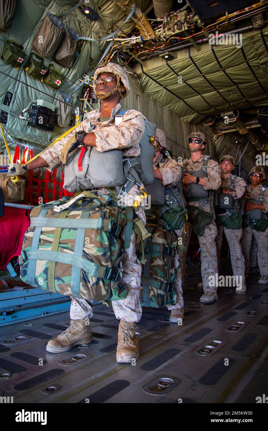 U.S. Marines assigned to Marine Aviation Weapons and Tactics Squadron One (MAWTS-1), prepare to conduct a static line jump from a KC-130J Hercules, during Weapons and Tactics Instructor (WTI) course 2-22, over the vicinity of Yuma, Arizona, March 23, 2022. The WTI course is a seven-week training event hosted by MAWTS-1, providing standardized advanced tactical training and certification of unit instructor qualifications to support Marine aviation training and readiness, and assists in developing and employing aviation weapons and tactics. Stock Photo