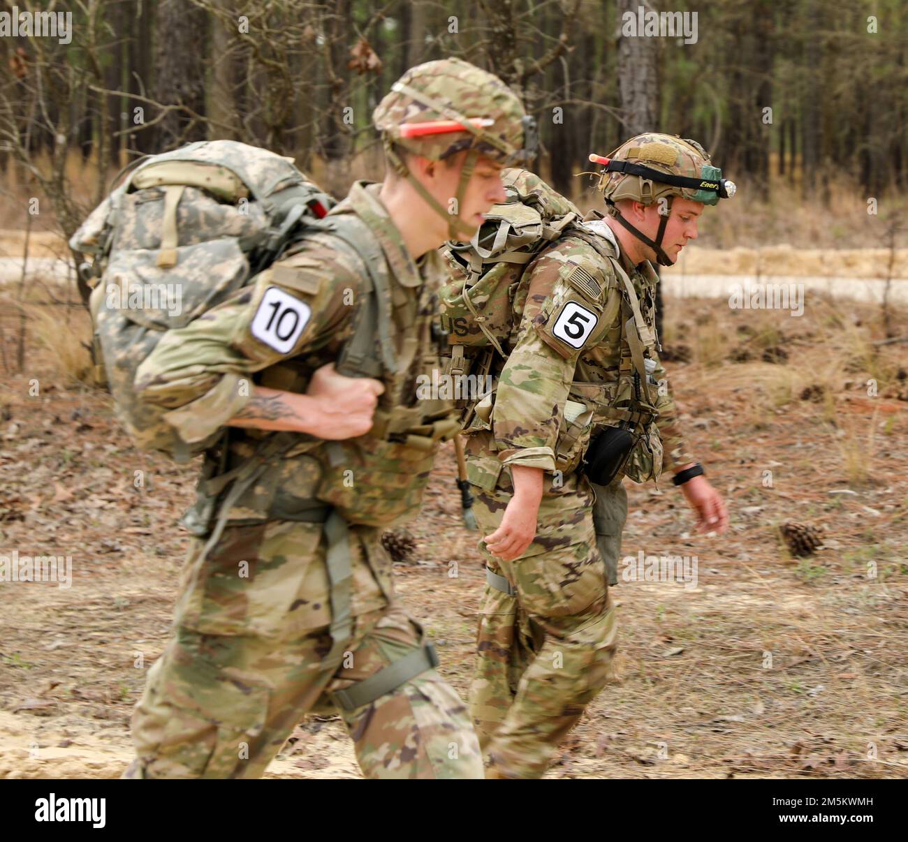U.S. Army soldiers participate in a ruck at Fort Bragg, N.C. on 23 March 2022. The soldiers from units on Fort Bragg competed in the Best CBRN Competition, which tests proficiency in their Military Occupation Specialty(MOS) skills, as well as knowledge of Warrior Tasks and Battle Drills. Stock Photo