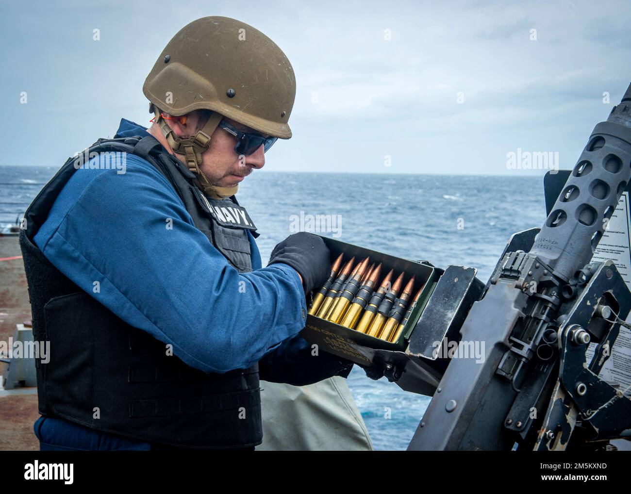 220323-N-FS190-1432 ATLANTIC OCEAN (March 23, 2022) Gunner's Mate 2nd Class David Diaz, assigned to the Arleigh Burke-class guided-missile destroyer USS Truxtun (DDG 103), loads rounds into a .50 caliber machine gun during a crew-served weapons shoot for Task Force Exercise (TFEX), March 23, 2022. TFEX is a scenario driven exercise that serves as certification for independent deploying ships and is designated to test mission readiness and performance in integrated operations. Truxtun is underway for Carrier Strike Group (CSG) 4 training evolutions. Stock Photo