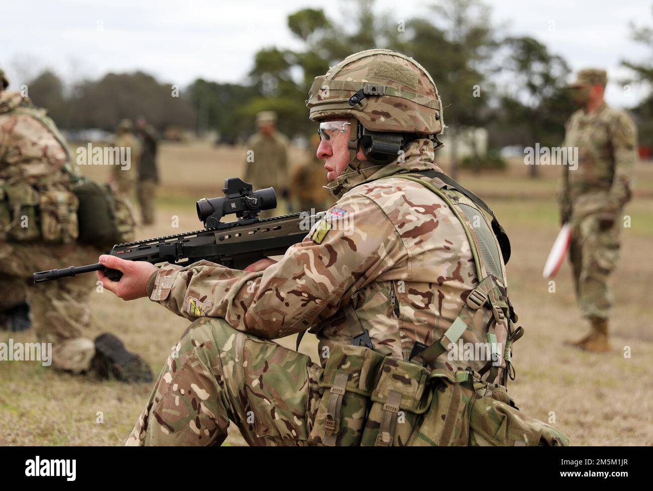 WO1 J. Douglas, a British Army Reserve service member readies his rifle