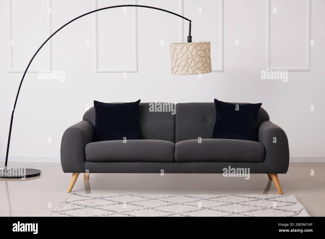 Interior of living room with black sofa and lamp Stock Photo - Alamy