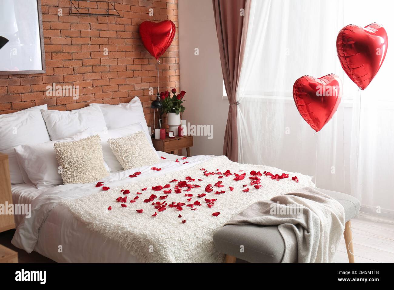 Interior of bedroom decorated for Valentine's Day with roses, candles and  balloons Stock Photo - Alamy