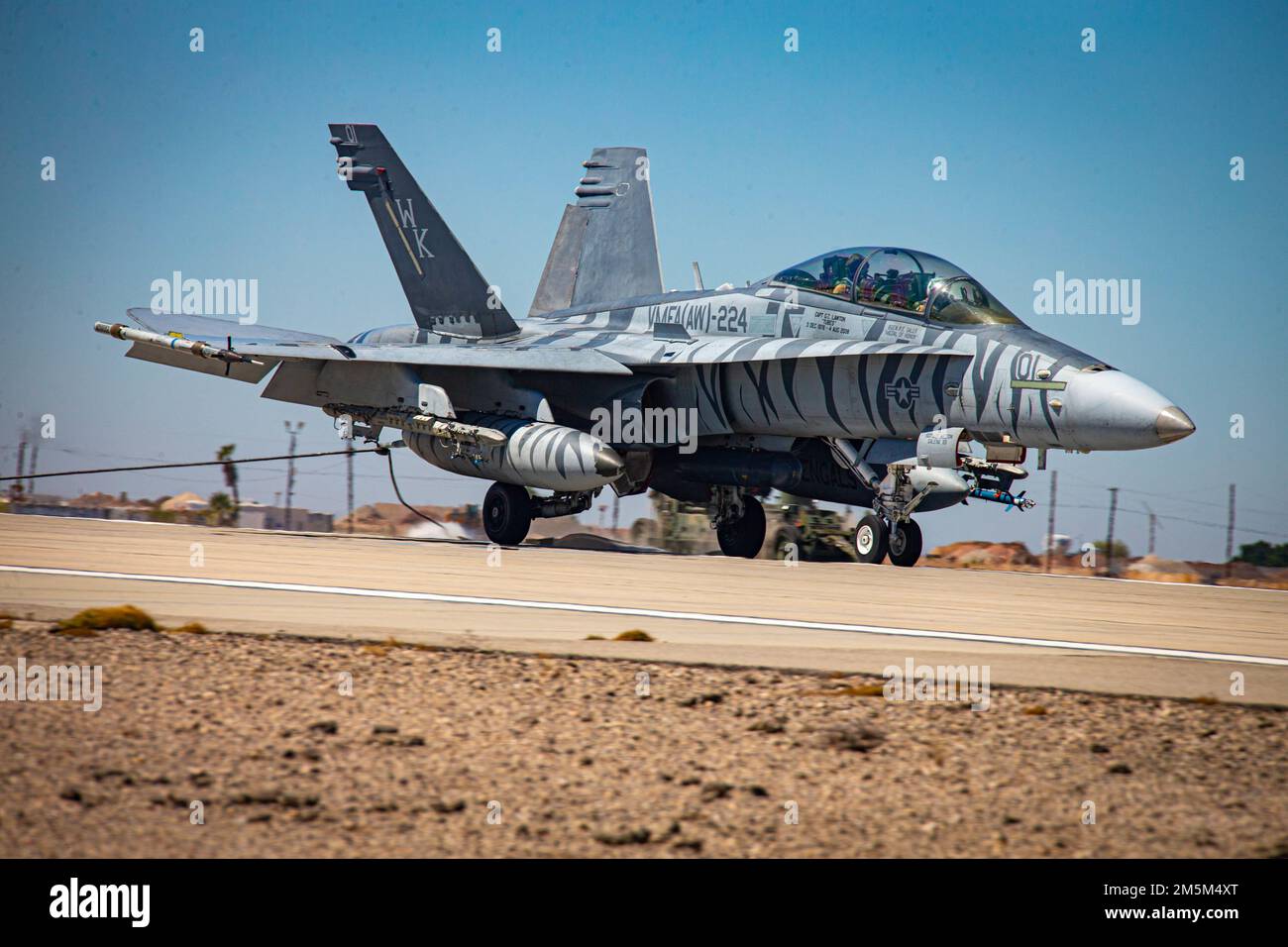 A U.S. Marine Corps F/A-18 Hornet latches onto an emergency arresting gear system, during an exercise as part of Weapons and Tactics Instructor (WTI) course 2-22, at Marine Corps Air Station Yuma, Arizona, March 24, 2022. WTI is a seven-week training event hosted by MAWTS-1, providing standardized advanced tactical training and certification of unit instructor qualifications to support Marine aviation training and readiness, and assists in developing and employing aviation weapons and tactics. Stock Photo