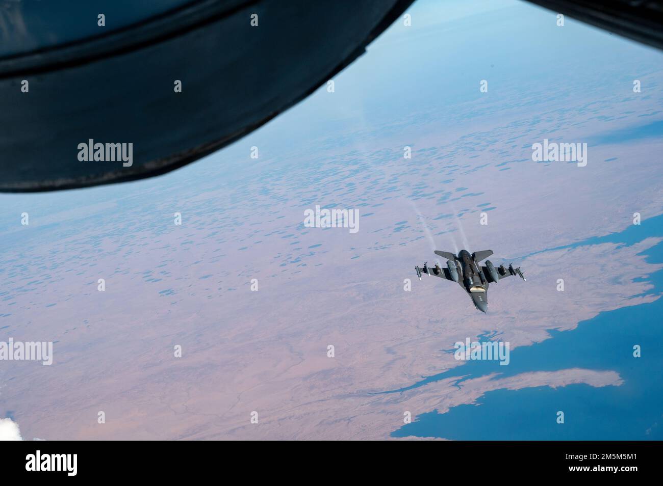 A U.S. Air Force F-16 Fighting Falcon flies over the U.S. Central Command area of responsibility March 24th, 2022. The F-16 Fighting Falcon delivers airpower and showcases Ninth Air Force (Air Forces Central)’s commitment to security and stability in the USCENTCOM AOR. Stock Photo