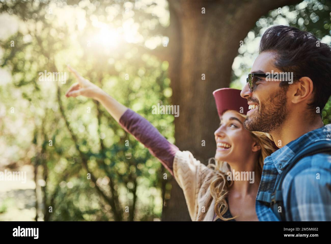 Do you see what I see. a happy young couple exploring nature together. Stock Photo