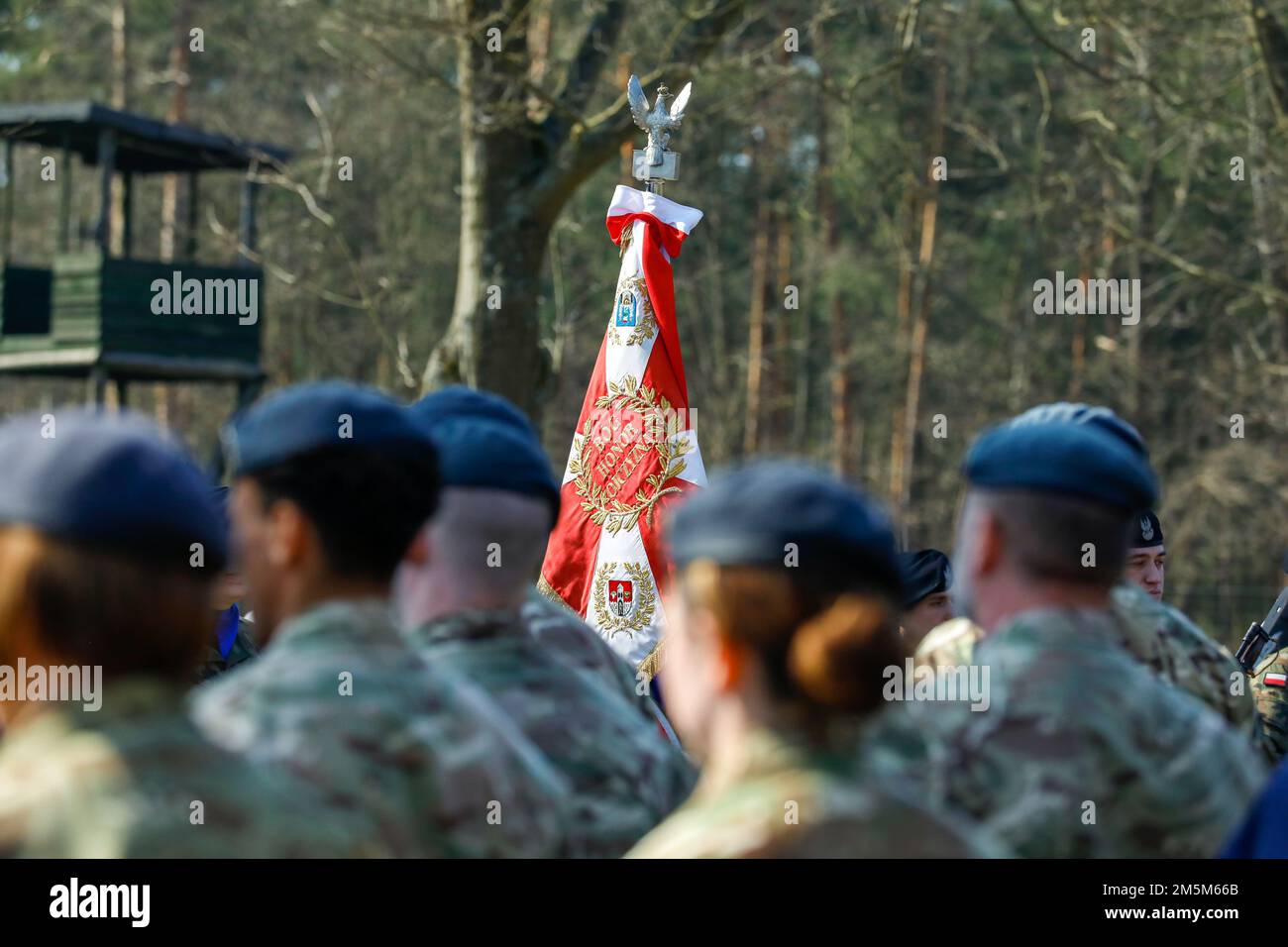 The flag of the Polish army stands during a commemoration of the escape attempt at Stalag Luft III at Zagan, Poland, March 24, 2022. Service members of various nations participated in the commemoration of what is known as the 'Great Escape,' an escape attempt orchestrated by British Royal Air Force airmen from a German prisoner of war camp in Zagan during World War II and ended in the execution of 50 recaptured prisoners. Stock Photo