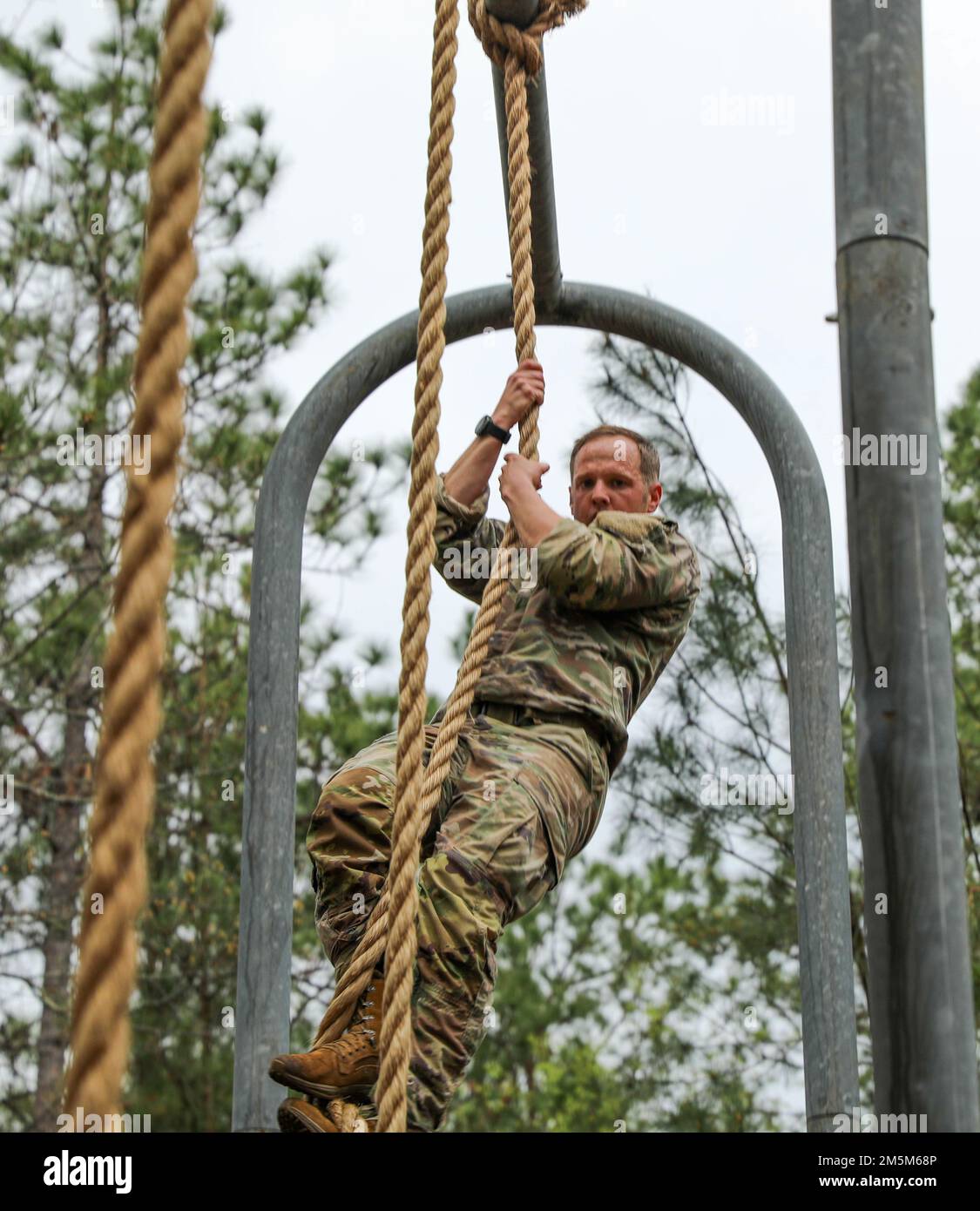 U.S. Army soldiers participate in an obstacle course at Fort Bragg, N.C. on 24 March 2022. The soldiers from units on Fort Bragg competed in the Best CBRN Competition, which tests proficiency in their Military Occupation Specialty(MOS) skills, as well as knowledge of Warrior Tasks and Battle Drills. Stock Photo