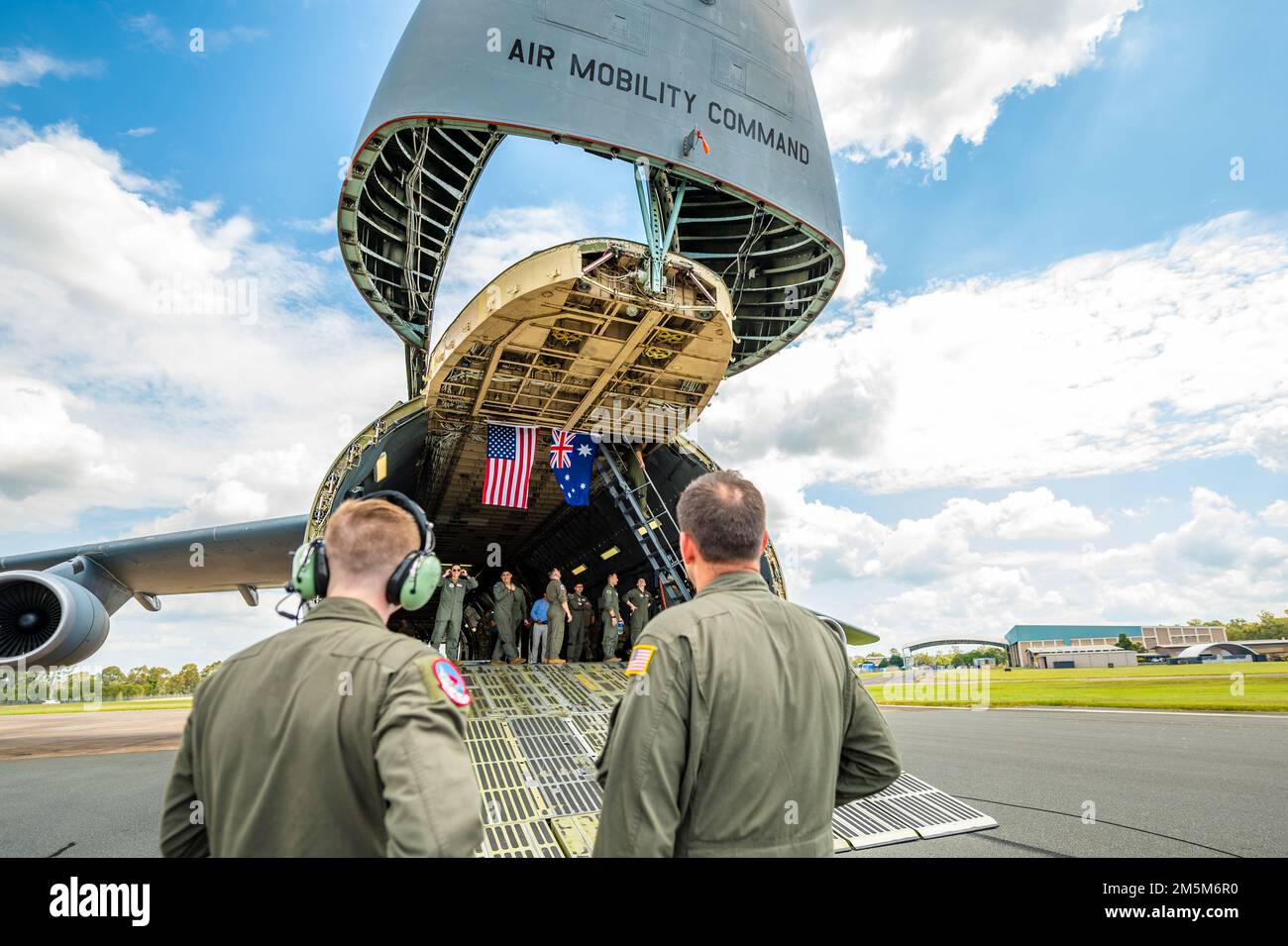 Members of the Australian Defence Force tour a U.S. Air Force C-5M Super Galaxy assigned to the 22nd Airlift Squadron at Travis Air Force Base, California, during a visit to Royal Australian Air Force Base Amberley, Australia, March 24, 2022. The 22nd AS commemorated the 80th anniversary of its establishment with a visit to RAAF Base Amberley March 23-27, 2022. The squadron was established April 3, 1942, as the 22nd Transport Squadron at Essendon Airport in Melbourne, Australia, coinciding with the establishment of several RAAF transport squadrons. The visit to RAAF Base Amberley allowed USAF Stock Photo