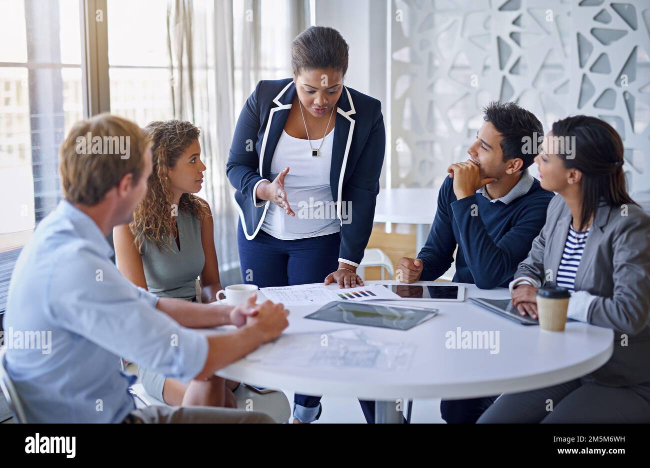 Getting down to business. a group of colleagues working together in an office. Stock Photo