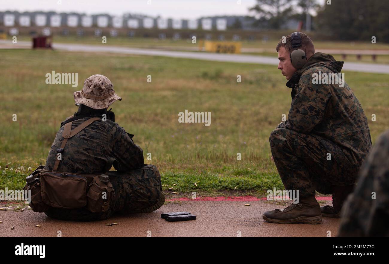 Coaches with Range Company, Weapons and Field Training Battalion instruct their recruits during the Table One course of fire on Marine Corps Recruit Depot Parris Island, S.C., March 24, 2022. Recruits shoot at the 200, 300, and 500 yard lines during this course of fire. Stock Photo