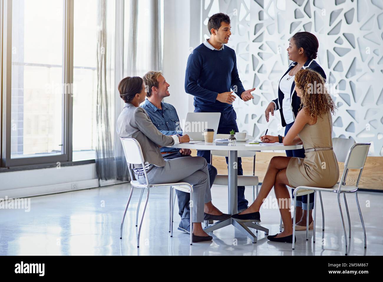 Sharing is business expertise. a group of colleagues working together in an office. Stock Photo