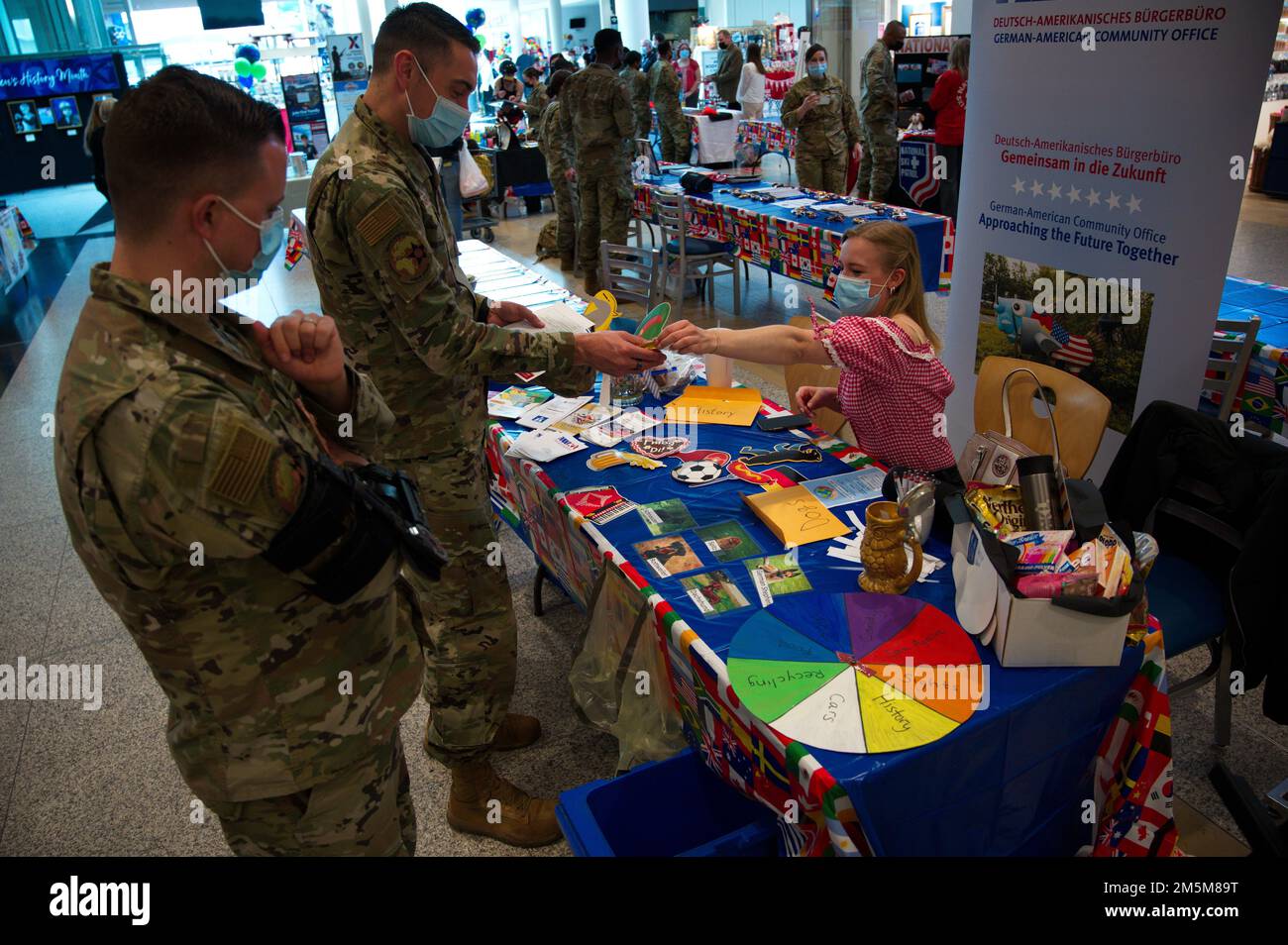 Lena Rheinardt, from the German-American Community Office, shares German culture and language with U.S. Air Force Airmen at Diversity Day 2022 on Ramstein Air Base, Germany, March 24, 2022. The theme ''Contributions of us ALL that makes US who we are today' showcased a base honor guard demo, poetry reading, salsa dancing, a bachata performance, Irish dancing and Polynesian dancing performed by Kaiserslautern Military Community members throughout the seven-hour event. Stock Photo