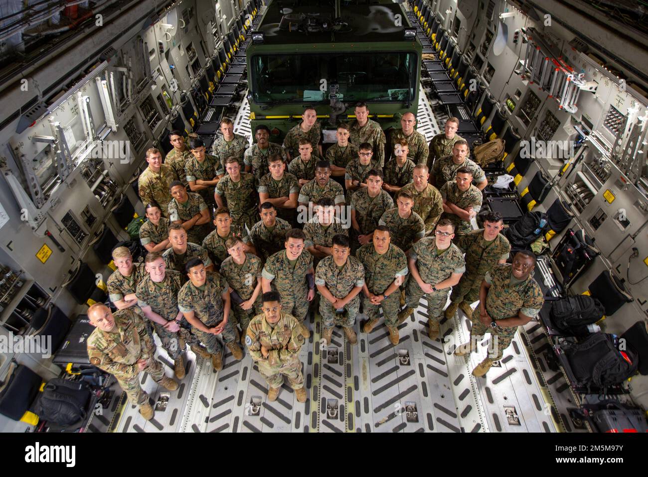 U.S. Marines with Marine Wing Support Squadron 271 and U.S. Airmen with 16th Airlift Squadron pose for a group photo on a C-17 Globemaster III during Strategic Mobility Exercise (STRATMOBEX) 22-1 at Marine Corps Air Station Cherry Point, North Carolina, March 24, 2022. STRATMOBEX 22-1 increased deployment readiness of unit mobility and embarkation capabilities in a joint environment. Stock Photo