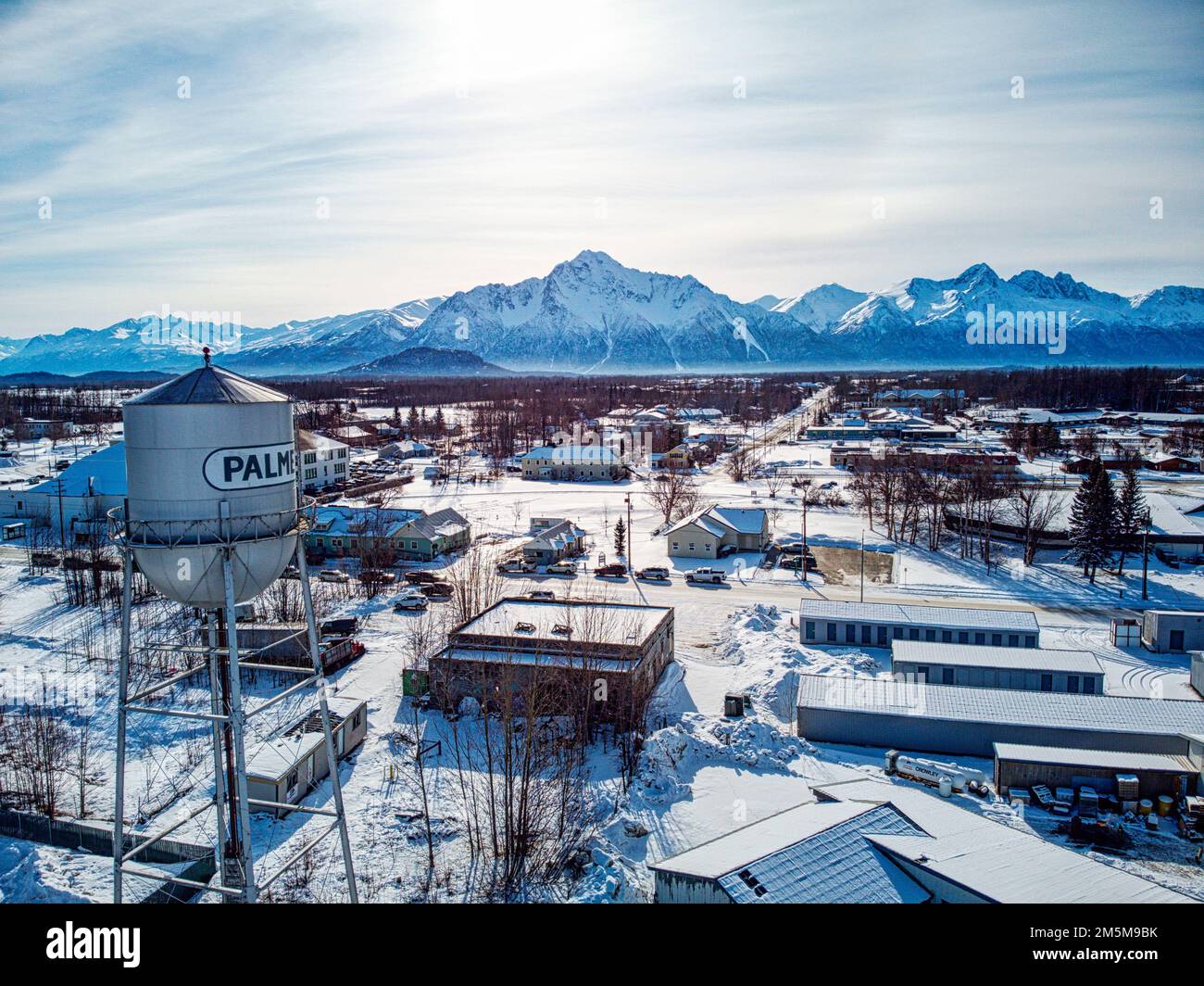An aerial winter view of the city of Palmer with some industrial buildings and mountains Stock Photo