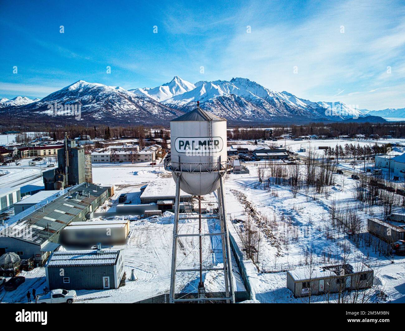 An aerial shot of the Palmer water tower and other buildings in the background on a snowy winter day Stock Photo