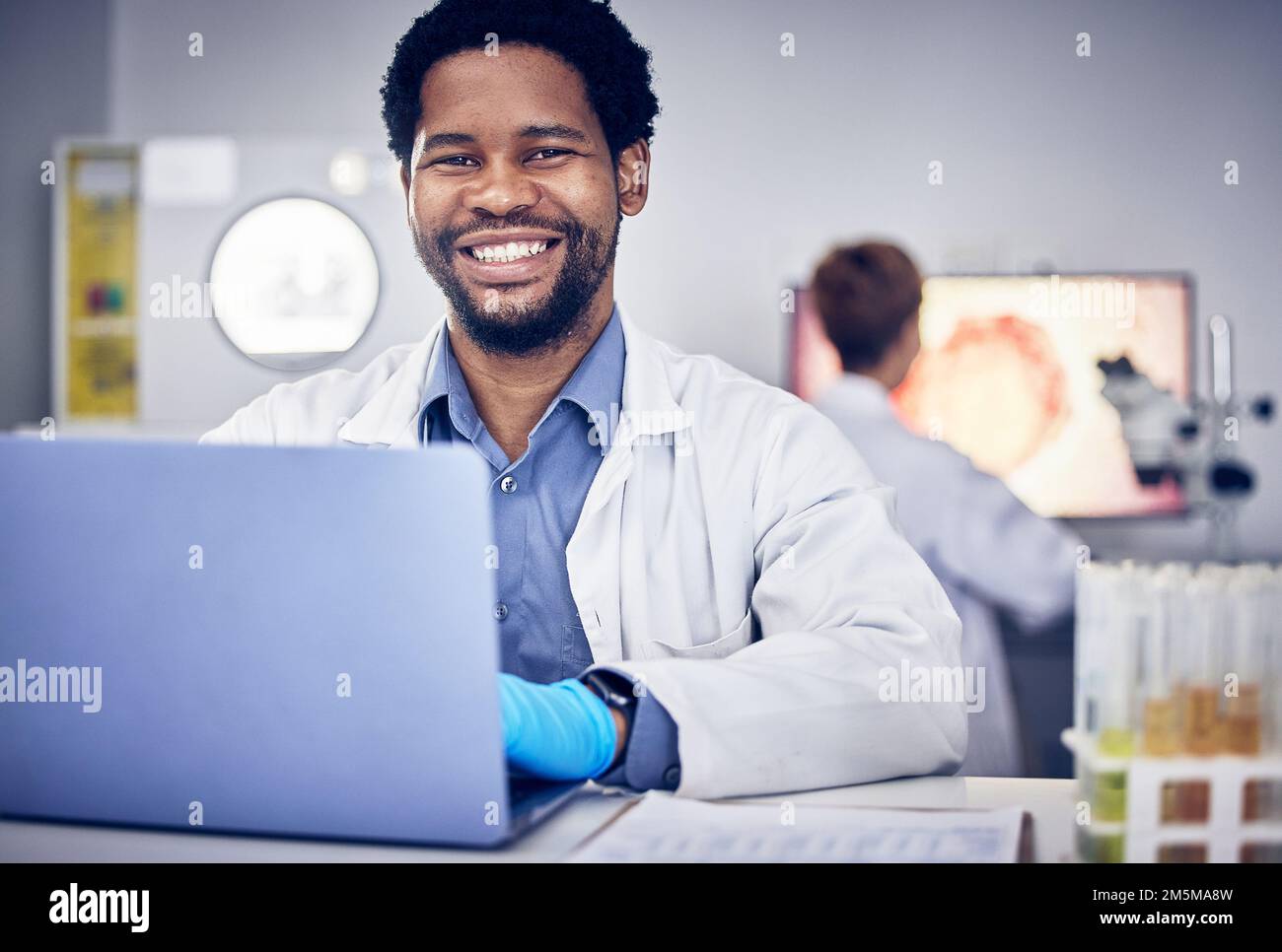 Portrait, scientist and black man with laptop, laboratory and research for healthcare. Male, researcher or science for medical diagnosis, cure and Stock Photo