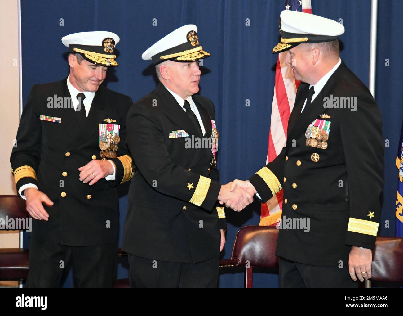 220325-N-GR655-0066 GROTON, Conn. (March 25, 2021) – Rear Adm. Rick Seif, outgoing commander of the Undersea Warfare Development Center (UWDC), shakes hands with his relief, Rear Adm. Martin Muckian, during a change-of-command ceremony at the Submarine Force Museum in Groton, Connecticut, March 25, 2022. UWDC, established on Sept. 1, 2015, leads the Navy’s undersea superiority; develops doctrine, concepts of operations, tactics, techniques, and procedures for undersea warfare; assesses undersea warfare performance and warfighting readiness of the fleet; provides training for undersea platforms Stock Photo