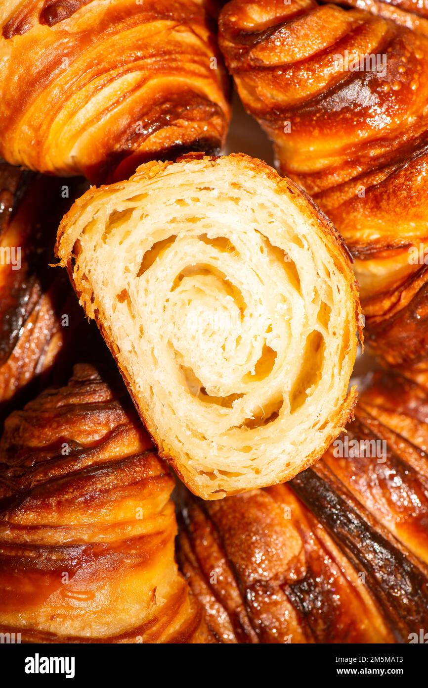 Detailed and closeup photo of a fresh baked plain buttery and flaky croissant. Stock Photo