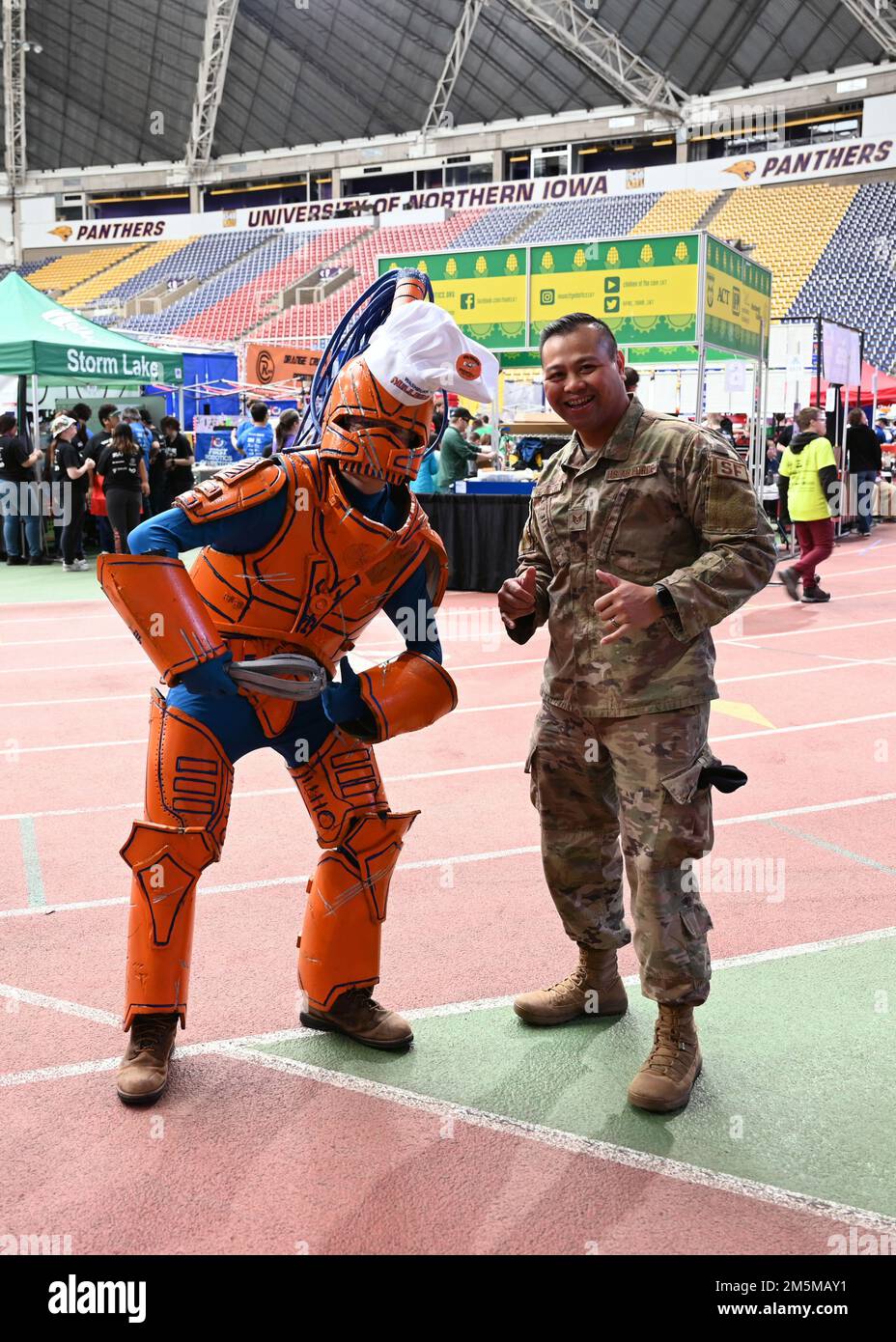 Staff Sgt. Marlon Alcampor, 343rd Recruiting Squadron enlisted accessions recruiter, poses with a team mascot at the FIRST (For Inspiration and Recognition of Science and Technology) Robotics Regional Competition in Cedar Falls, Iowa, March 25, 2022. High Schools from six different states had teams competing with over 60 different teams. Stock Photo