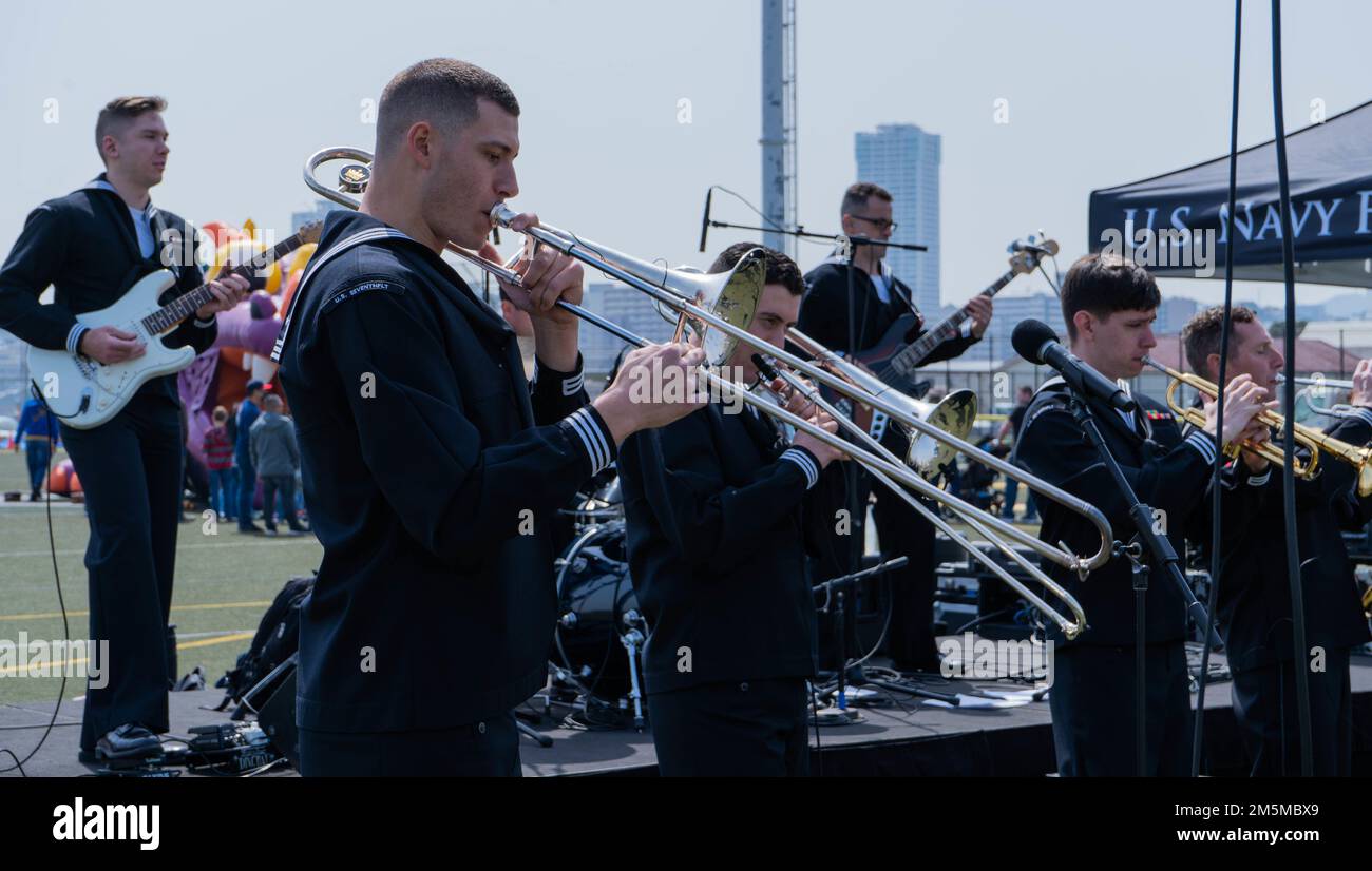 220325-N-RC359-1092 YOKOSUKA, Japan (March 25, 2022) Sailors assigned to the U.S. Navy 7th Fleet Band perform at the USS Ronald Reagan command picnic at Purdy Field onboard Commander, Fleet Activities Yokosuka. Ronald Reagan, the flagship of Carrier Strike Group 5, provides a combat-ready force that protects and defends the United States, and supports alliances, partnerships and collective maritime interests in the Indo-Pacific region. Stock Photo