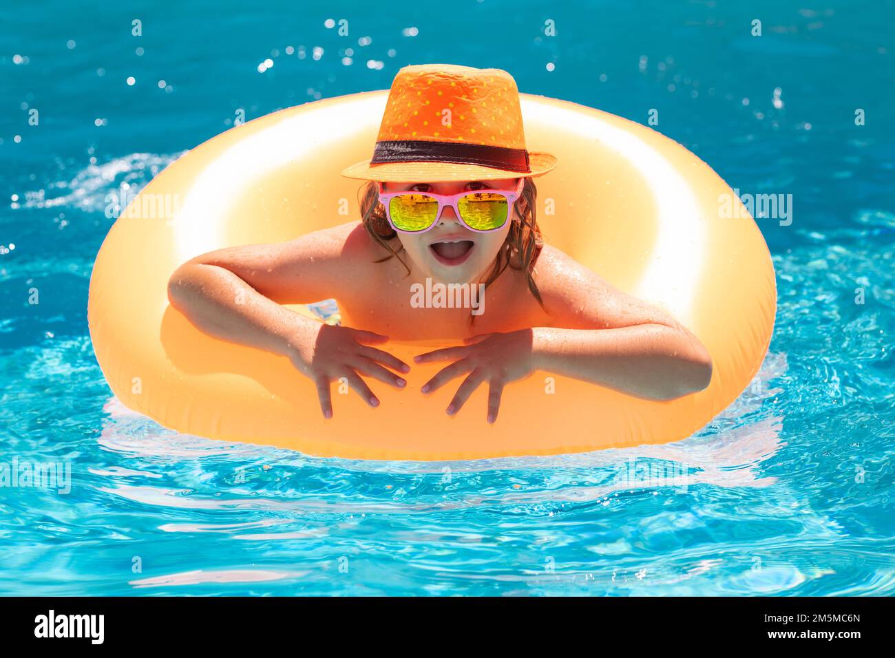 Children playing in pool. Child in swimming pool. Summer lifestyle
