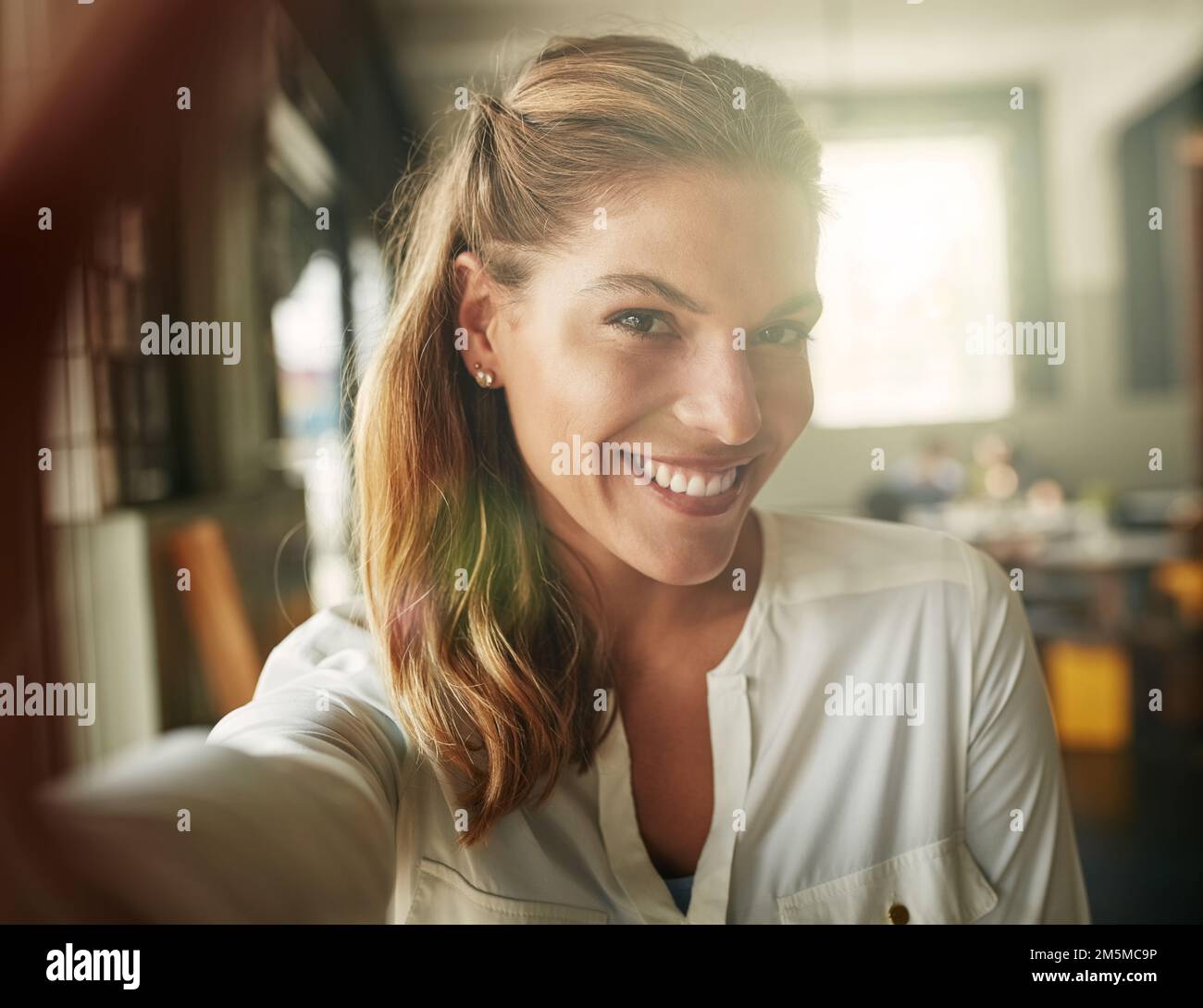 Taking a selfie in her favourite coffee shop. an attractive young woman in a coffee shop. Stock Photo