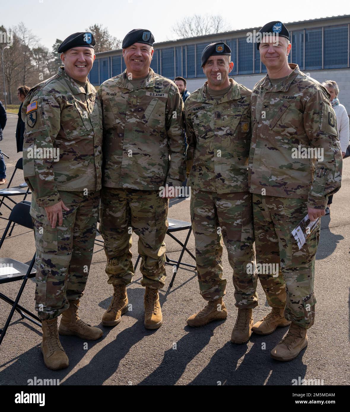Brig. Gen. Jed Schaertl (left) , deputy commanding general for mobilization and reserve affairs with the U.S. Army Europe and Africa Command, stands with Col. Patrick Schuck (right), commander, 12th Combat Aviation Brigade, Command Sgt. Maj. Zane Hanson, 12 CAB command sergeant major,  and Chief Warrant Officer 5 Robert Slider, 12 CAB command chief warrant officer on the parade ground of Herrenwaldkaserne barracks, Germany, March 25, 2022. The 12th Combat Aviation Brigade was invited to attend the change of command for the Rapid Response Forces Division. 12 CAB is among other units assigned to Stock Photo