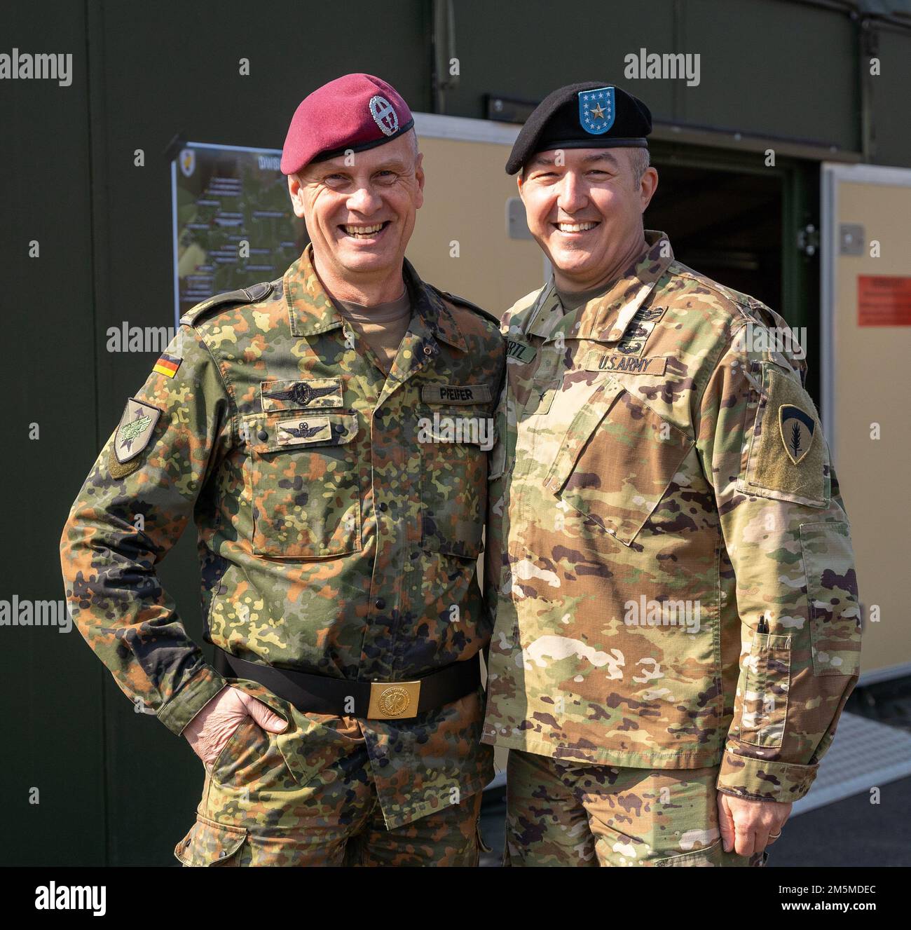 Brig. Gen. Andreas Pfeifer (left), deputy commander, Rapid Response Forces Division, smiles for a photo with Brig. Gen. Jed Schaertl (right), deputy commanding general for mobilization and reserve affairs with the U.S. Army Europe and Africa Command, on the parade ground of Herrenwaldkaserne barracks, Germany, March 25, 2022. The 12th Combat Aviation Brigade was invited to attend the change of command for the Rapid Response Forces Division. 12 CAB is among other units assigned to V Corps, America's Forward Deployed Corps in Europe that works alongside NATO Allies and regional security partners Stock Photo