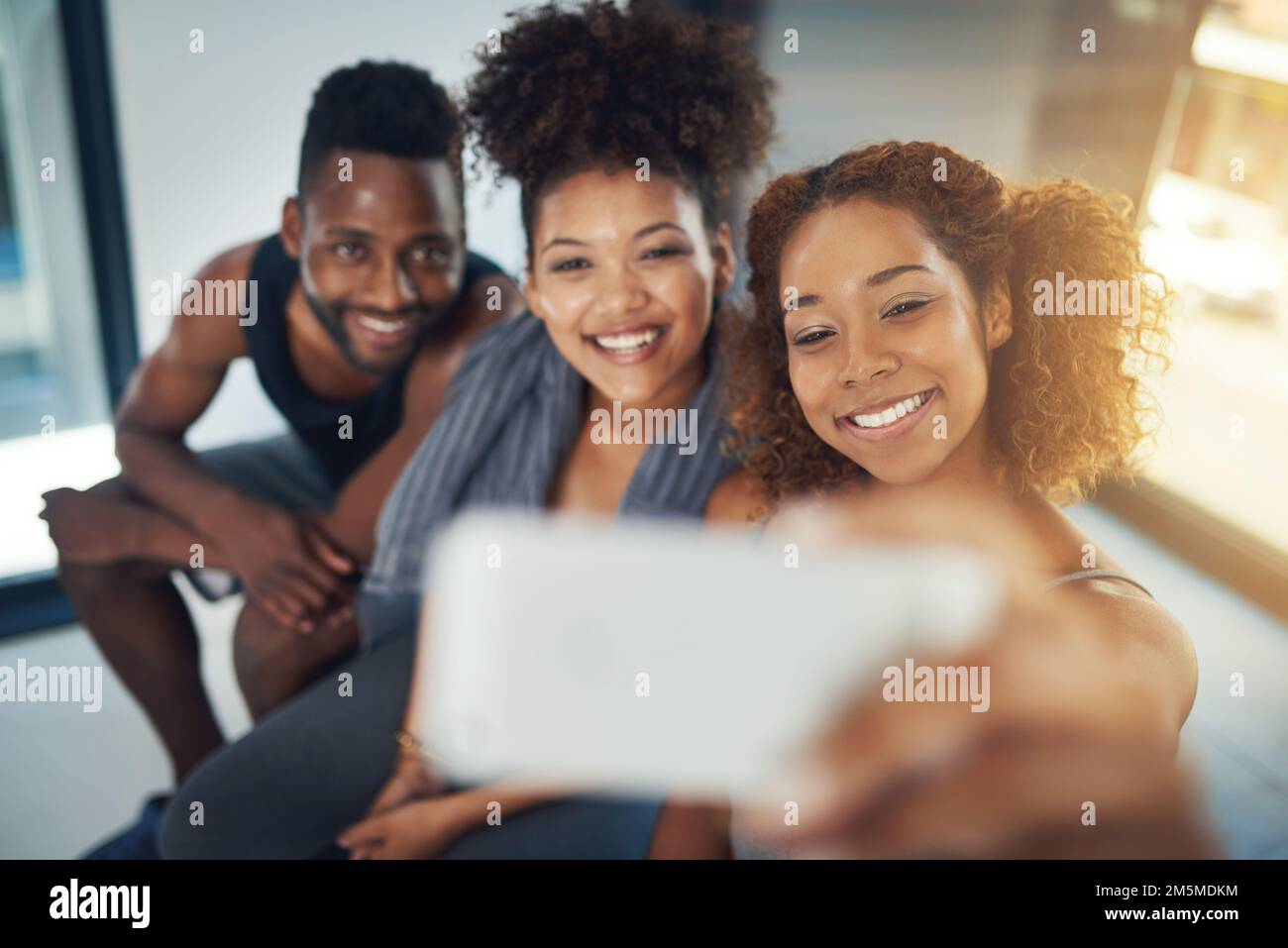 Do it for yourSelfie. three young people taking a selfie after yoga ...