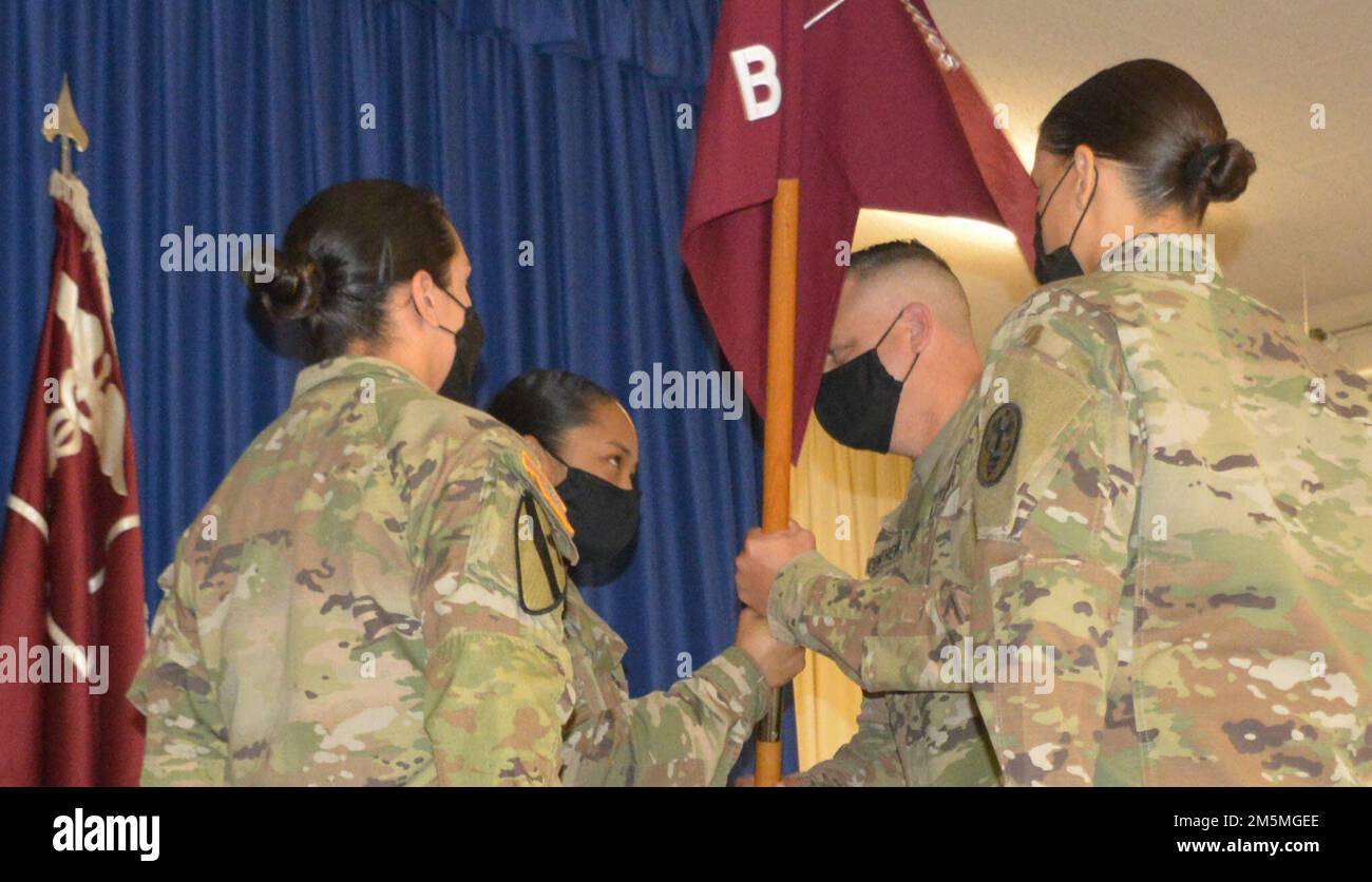 Sgt. 1st Class Pamela Dupar, noncommissioned officer in charge for Deputy Commander for Surgical Services, hands the guidon to outgoing Bravo Company, 1st Sgt. Victor Contreras Jr., during a change of responsibility ceremony at Tripler Army Medical Center, March 25, 2022. Contreras then gave the guidon to Capt. Ashley C. Robbins, company commander, Bravo Co., whom passed it to the inbound 1st Sgt. Hadasa I. Lopez, thus formally accepting the responsibility of the Command. Stock Photo