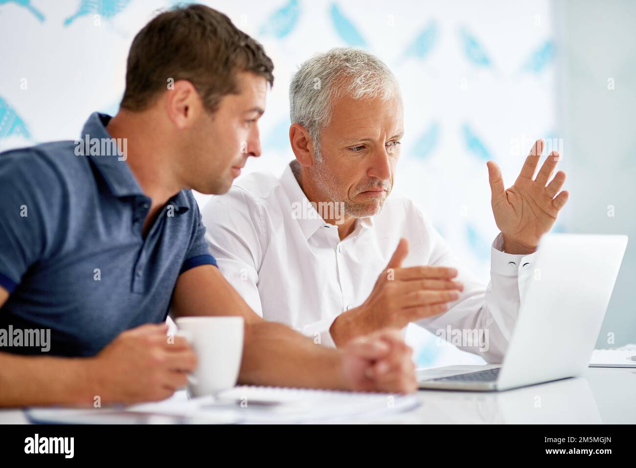 Looking at the bigger picture. two men working in the office. Stock Photo