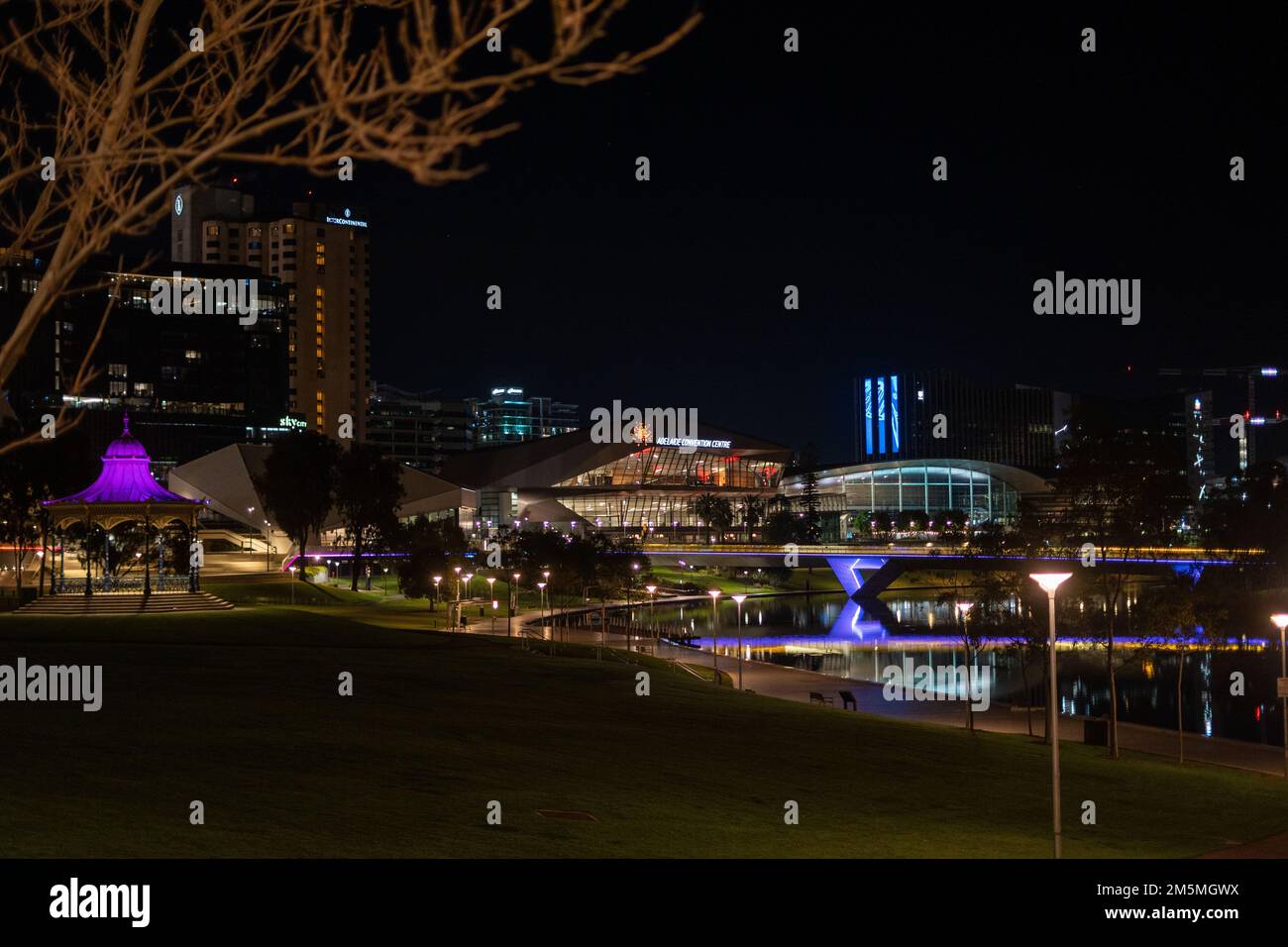 A night view of illuminated bridge and buildings by Torrens river in Adelaide city Stock Photo