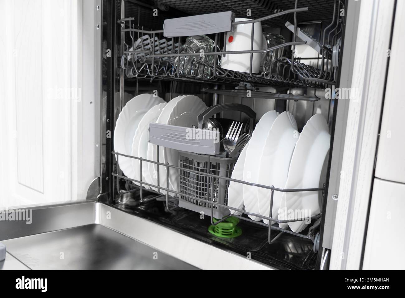 Internal shelves of dishwasher for the distribution of dishes and a basket for cutlery. Brand