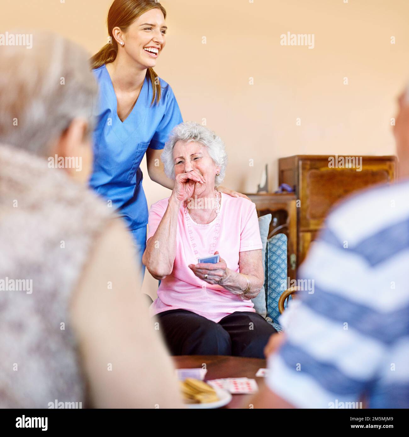 Theyre having a really enjoyable game. seniors playing cards in their retirement home. Stock Photo